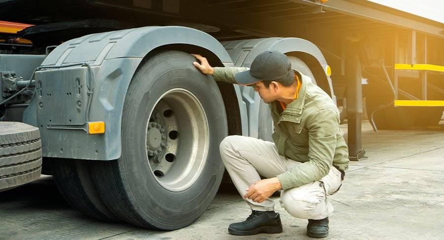 A driver performing a truck inspection.