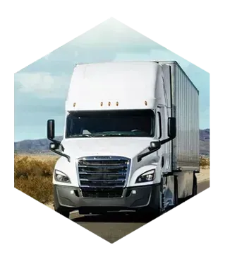 White tractor trailer driving on a desert road